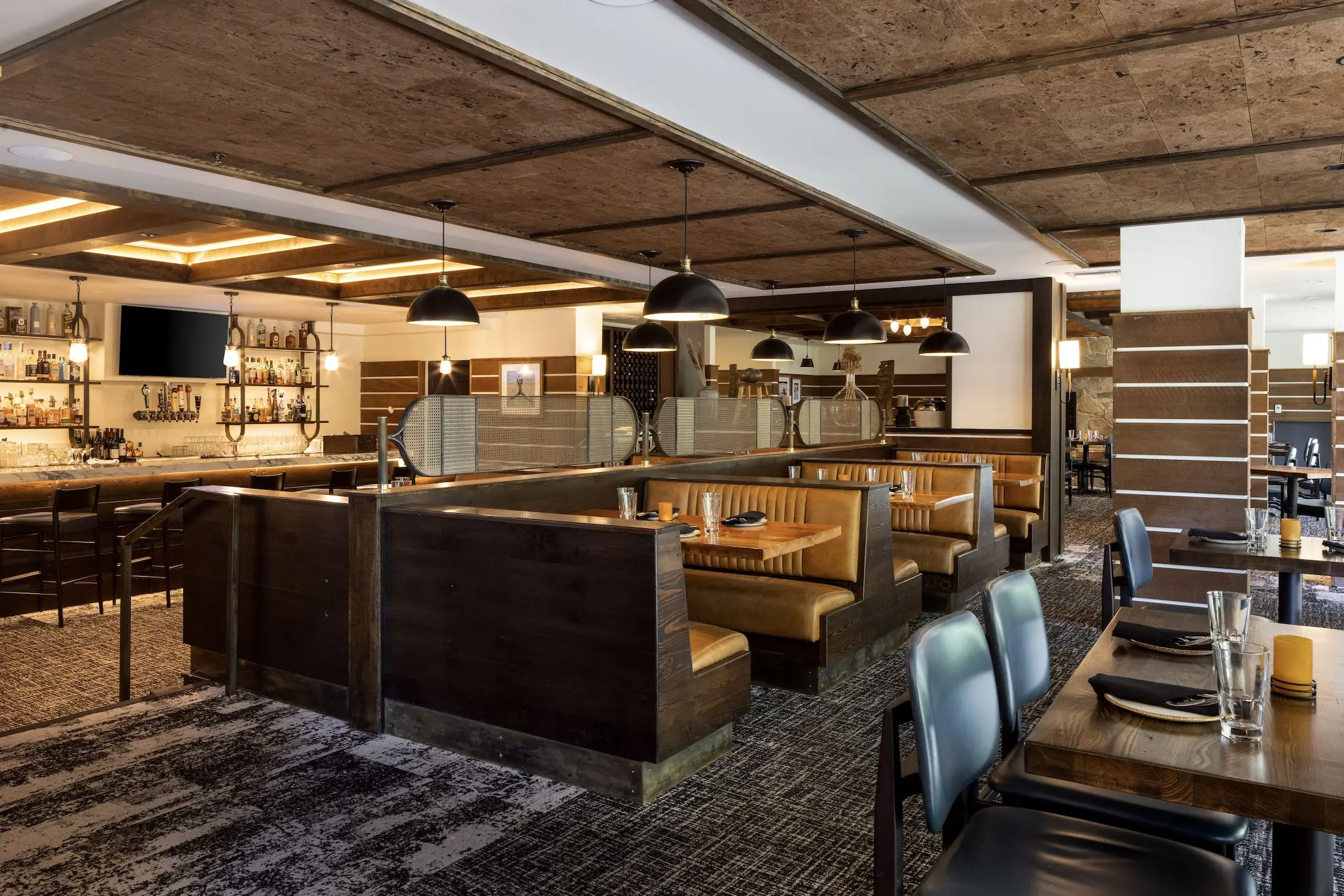 Interior of Spur restaurant and Bar with a beautiful bar, booths, and tables