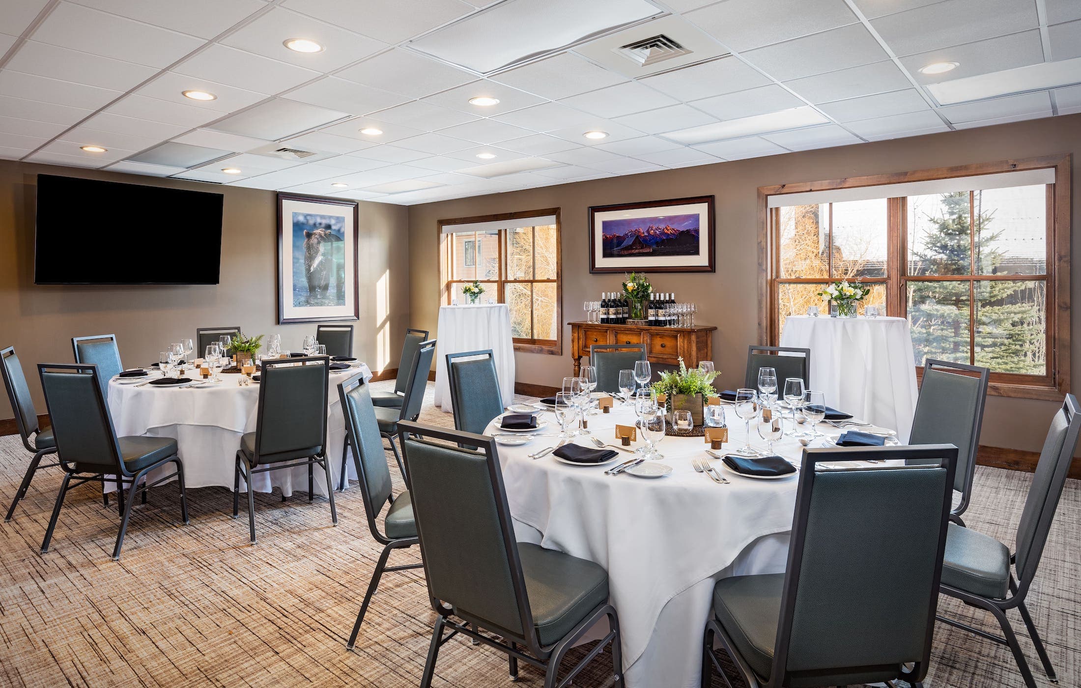 Two round tables set up for an event in the Four Pines Meeting Room at Teton Mountain Lodge