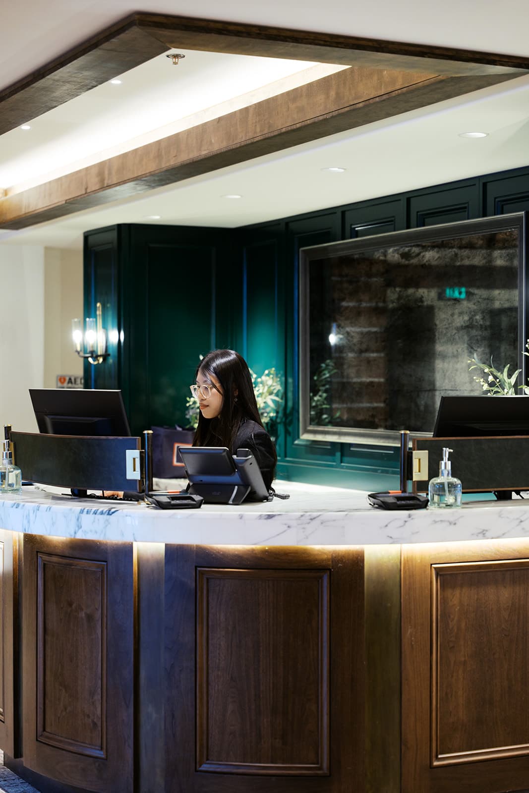 A photo of a reception desk with a receptionist