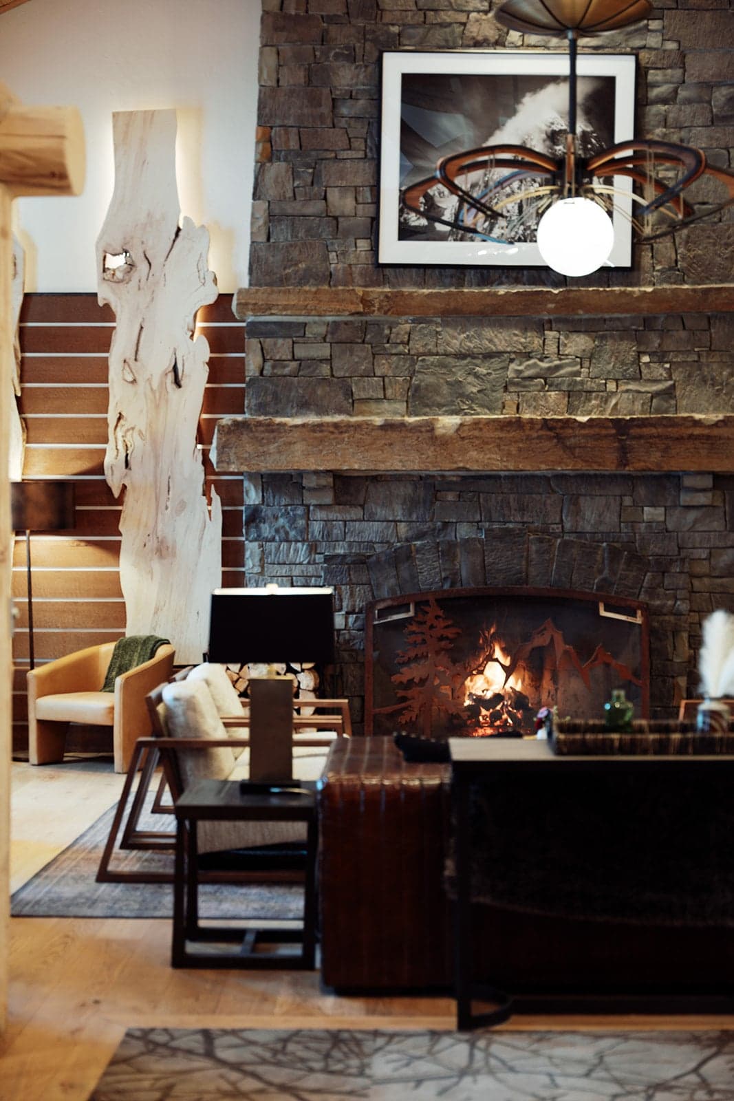 A photo of a lounge with a stone fireplace and seating