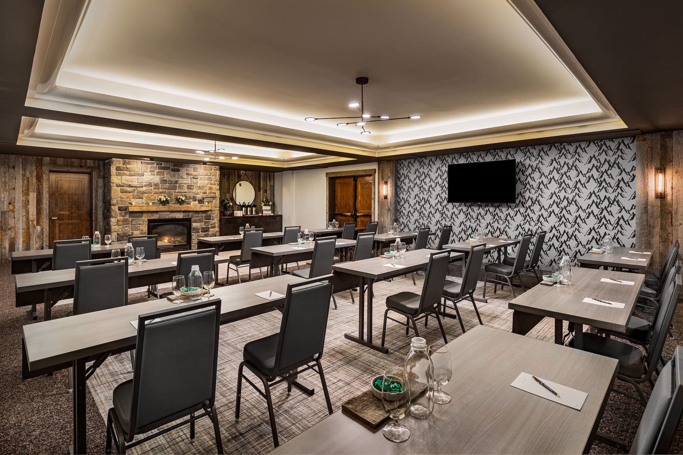Twelve rectangle tables set up in a meeting room at Teton Mountain Lodge