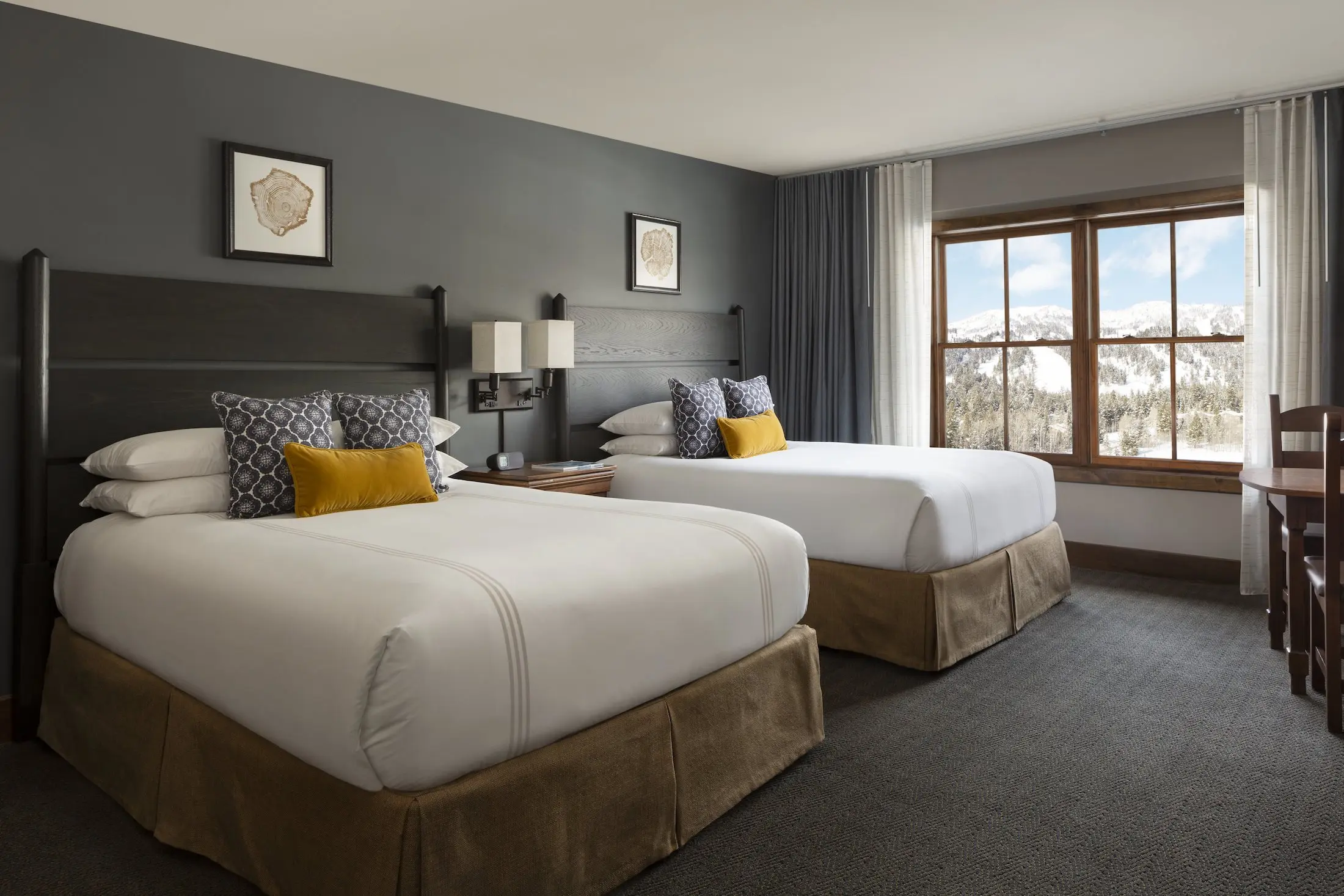Large room with 2 queen beds, and a beautiful view of the mountains in the Teton Mountain Lodge Two Queen Beds Lodge Room
