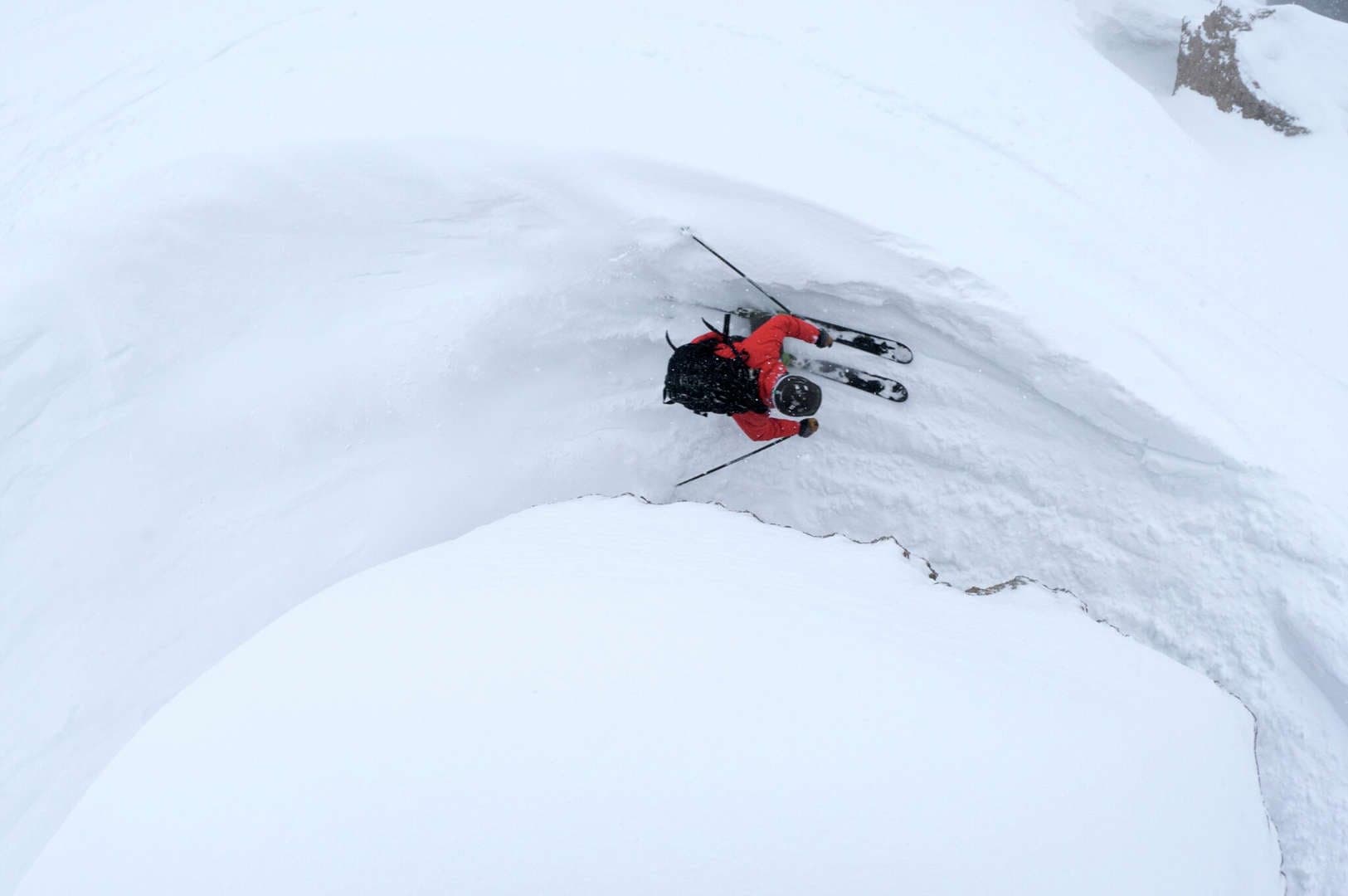 A person skis down a slope in a top-down perspective