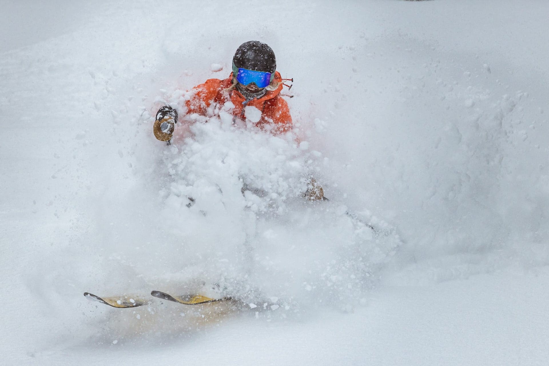 A photo of a person ripping down a slope on a snowboard