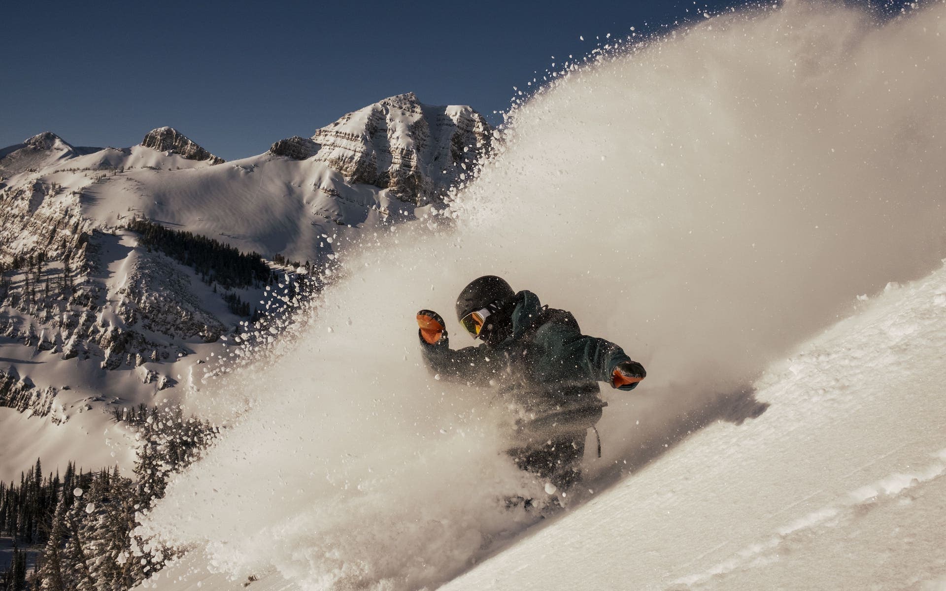 A photo of a person ripping down a slope on a snowboard