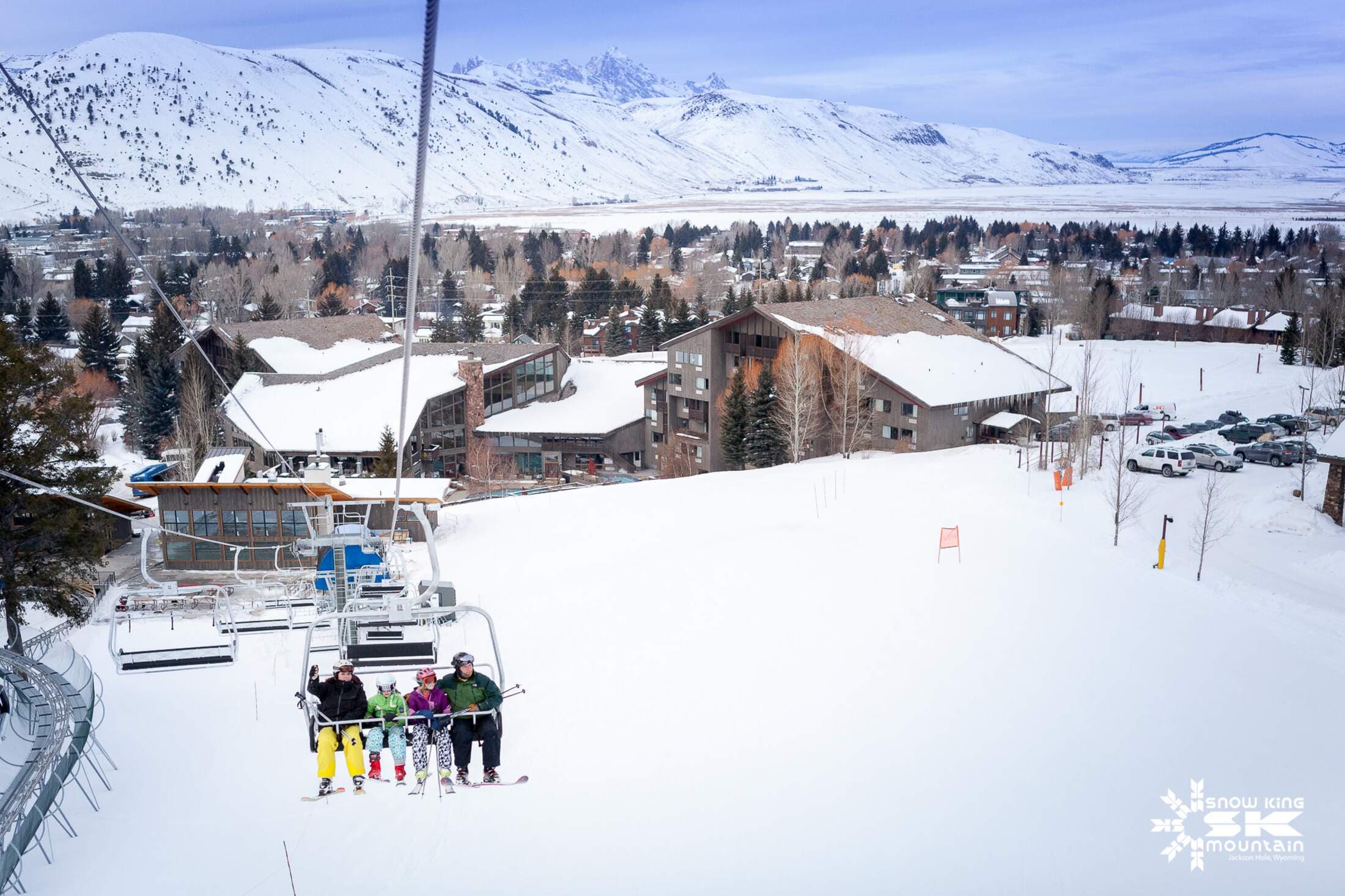 A group going up the chairlift at Snow King resort.